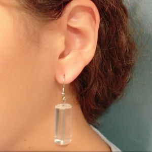 Clear cylinder earring.